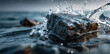 © Anisah - A close-up shot of a dark rock submerged in water, creating a dynamic splash with droplets frozen in motion.