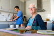 © Maskot - Portrait of smiling senior woman sitting at table for breakfast in home
