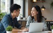 © William - Two young Asian startup company partners discuss and brainstorm in casual small business office, marketing planning jobs on a laptop, and freelance work as E-commerce entrepreneur and coworker team.