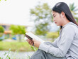 © Яe Life Яe World - Young adults woman enjoyment read book at park in holiday for relaxation, leisure, studying, brainstorming. Lifestyle people Asian female happy learn education goal planning new beginnings. Knowledge