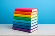 © Acrdesign - Stack of colorful rainbow books on blue background