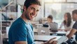 © Sora - Happy Young Man Wearing Blue T Shirt Smiling While Using Tablet in Bright Modern Office