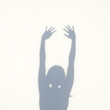 © FZ - Shadow of a person reaching up with hands outstretched.