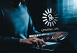 © Supatman - Software Update and System Upgrade Concept. Person holding phone while using laptop with software update progress interface and security, technology maintenance, application upgrades, system security.