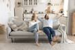 © fizkes - Happy middle aged couple flopping with joy on comfy sofa