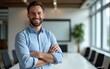 © wang - Portrait of cheerful businessman with arms folded standing in conference room. Happy young business man in shirt looking at camera. Portrait of a smiling businessman in modern office. High quality
