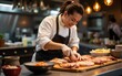 © li - Chinese chef prepares fish in a restaurant kitchen. High quality