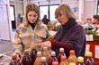 © salajean - Mother and daughter choose bottled juices at market stall