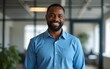 © Betty - A middle-aged African American man standing at office, wearing blue shirt. High quality