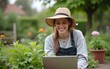 © Helen - Female gardener using laptop. High quality