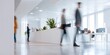 © inspiretta - Group of people walking in a large office building