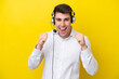 © luismolinero - Telemarketer caucasian man working with a headset isolated on yellow background celebrating a victory in winner position