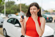 © luismolinero - Young pretty Ukrainian woman holding car keys at outdoors with surprise and shocked facial expression