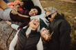 © Jacob Lund - Friends laughing together outdoors