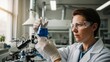 © Twenty One Studio - Scientist in lab coat holding a flask with blue liquid in a laboratory.