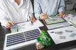 © Charlie's - Solar panels green energy Business man working green eco friendly office business creative idea Planing Bio economy for business eco friendly professional Engineer sustainable electricity.