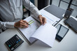 © Charlie's - Professional Reviewing Business Data and Using Calculator.