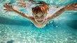© sorin - A young boy and his family delight in underwater swimming fun during their summer vacation pool time