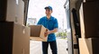 © Vasiliy - Smiling delivery man loading a cardboard box into a van. Friendly courier in a blue uniform providing professional shipping service.