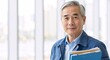 © Vasiliy - Confident senior asian worker smiling at the camera. Portrait of an experienced male manager or engineer in a factory holding a clipboard with copy space
