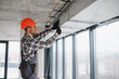 © Serhii - Construction worker installing ventilation system in building