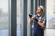 © Serhii - Construction worker applying sealant to window in modern building
