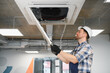 © Serhii - Hvac technician repairing air conditioner unit wearing hard hat and gloves