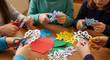 © InfinityVisuals - Creative Hands at Work: Children's hands cut delicate paper snowflakes, their small scissors precise. This scene portrays artistic expression and holiday creativity.