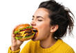 © Emil - young caucasian woman, dark messy hair, yellow chunky sweater, intensely biting a gourmet cheeseburger with ecstatic pleasure on a transparent background. concept for fast food advertising