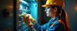 © Viktor - Woman electrician in safety gear inspects electrical panel wiring. She works on complex system with tools, wearing helmet and gloves inside building. Professional female technician checks circuits.