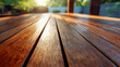 © Mikhail Vorobev - Sunlit wooden outdoor table surface with natural texture and warm tones creating a peaceful backyard atmosphere during golden hour in the evening light