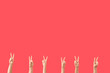© Pixel-Shot - Female hands showing peace gestures on red background