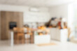 © Pixel-Shot - Blurred view of light kitchen decorated for Halloween with white counters and table