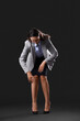 © Pixel-Shot - Businesswoman in pose of marionette on dark background