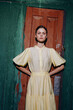 © SHOTPRIME STUDIO - woman portrait dress vintage standing confident in doorway with authenticity and inclusivity, fashion style, natural light, strong gaze