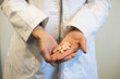 © Phoscar - Doctor's Hands Holding Prescription Pills or Capsules, Medication Management and Treatment