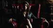 © anis rohayati - Woman in leather jacket sitting in red armchair