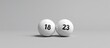 © Cherrin - Two lottery balls displaying the numbers 18 and 23 on a neutral background.