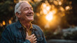 © CinimaticWorks - elderly man with hand on chest smiling warmly in golden hour park environment representing gratitude happiness and calm life