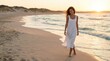 © Albert - Woman in white dress walking along a sandy beach at sunset with gentle waves