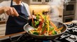 © ArotiRani - Person cooking stir fry with fresh vegetable mix in wok