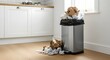 © antuanetto - Overflowing garbage bin with crumpled paper spilling onto the floor in a bright modern kitchen for waste management concept and everyday mess