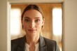 © Aliaksandr Barouski - Professional woman in a doorway frame, presenting confident business style.