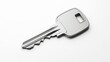 © Yurgentum - A single, clean, silver-colored key with a brushed metal texture lies diagonally on a pristine white background. The image evokes themes of security, access, and ownership.