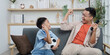 © itchaznong - Family Life: Joyful father and son celebrating soccer victory at home