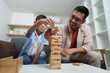 © itchaznong - Family Life: Engaging playtime with father and son building a tower