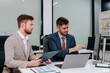 © NINENII - Diverse professionals collaborate on project analysis with financial graphs. Strategic teamwork and insights drive company growth and success.