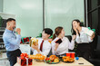 © NINENII - Asian people, celebrating together and gift exchange at Merry Christmas & Happy New Year. excited businessman feel happy work complete and celebration successful deal.