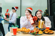 © NINENII - Asian people, celebrating together and gift exchange at Merry Christmas & Happy New Year. excited businessman feel happy work complete and celebration successful deal.