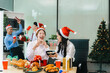 © NINENII - Asian people, celebrating together and gift exchange at Merry Christmas & Happy New Year. excited businessman feel happy work complete and celebration successful deal.